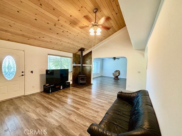 living room with high vaulted ceiling, a wood stove, wooden ceiling, ceiling fan, and hardwood / wood-style floors