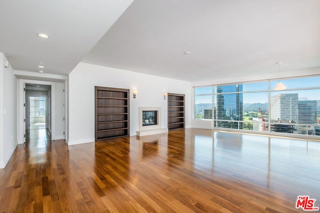 unfurnished living room featuring hardwood / wood-style flooring