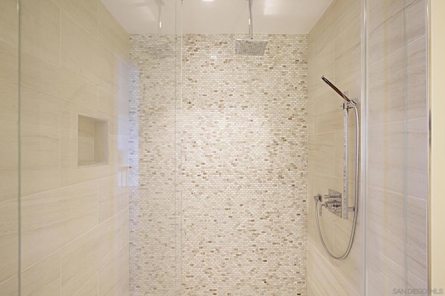 bathroom with tiled shower