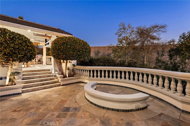 view of patio terrace at dusk