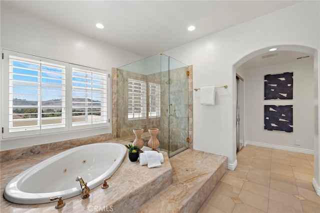 bathroom featuring tile patterned flooring and independent shower and bath