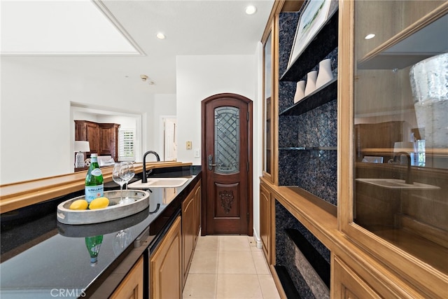 interior space with light tile patterned floors and sink