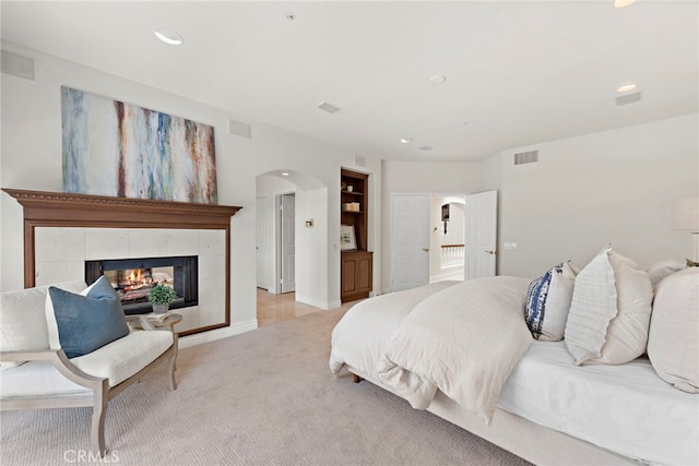 carpeted bedroom with a fireplace