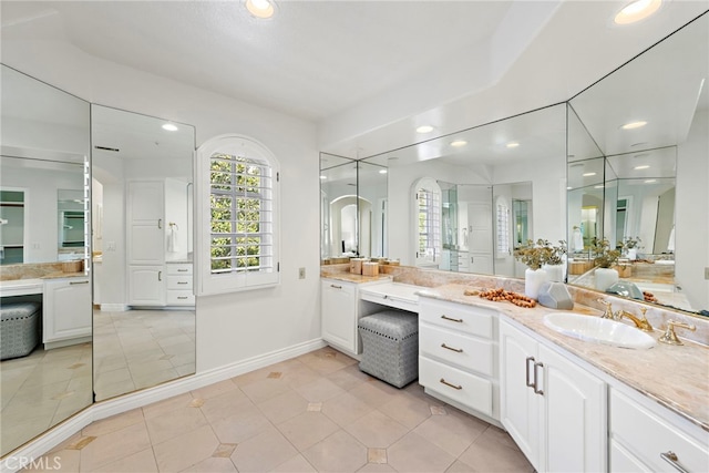 bathroom with tile patterned flooring and vanity