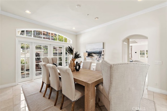 dining space with french doors, ornamental molding, and light tile patterned flooring