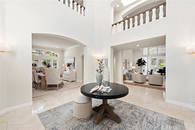 tiled foyer featuring a high ceiling and french doors