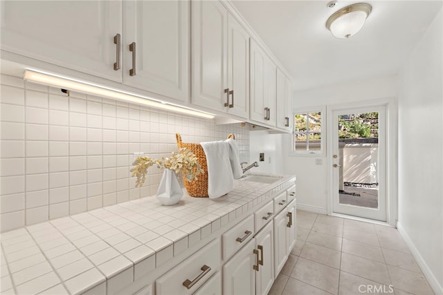 mudroom with sink and light tile patterned floors