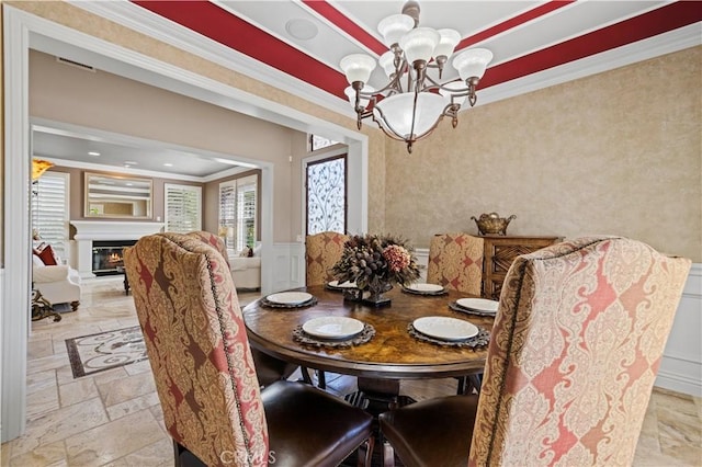 dining area featuring an inviting chandelier and crown molding