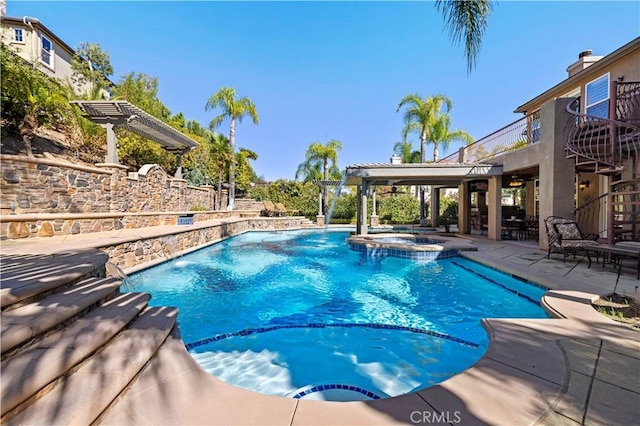 view of swimming pool featuring pool water feature, a pergola, an in ground hot tub, and a patio