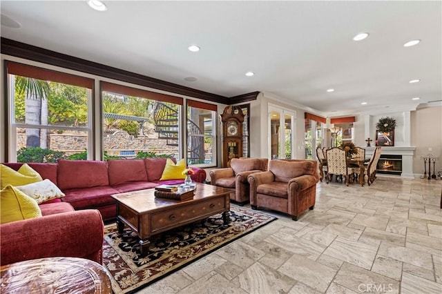 living room with plenty of natural light and ornamental molding