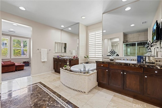 bathroom featuring vanity and shower with separate bathtub