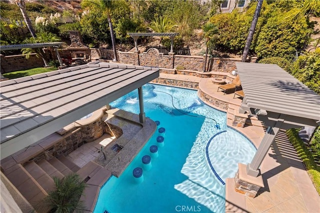 view of swimming pool with a patio area and exterior fireplace