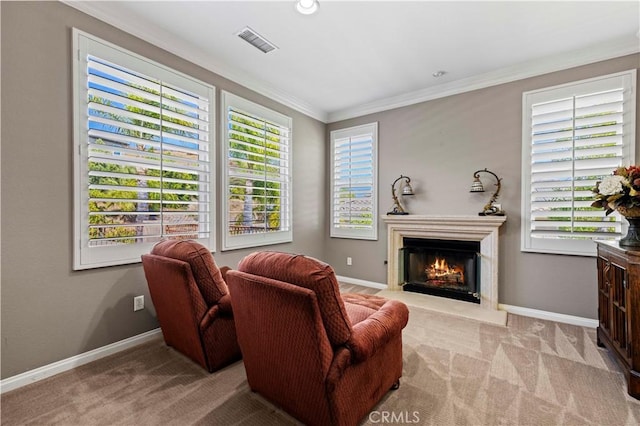 sitting room featuring light colored carpet and ornamental molding