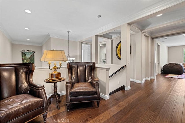 living area with dark wood-type flooring and ornamental molding