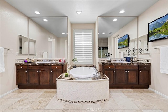 bathroom with vanity and separate shower and tub