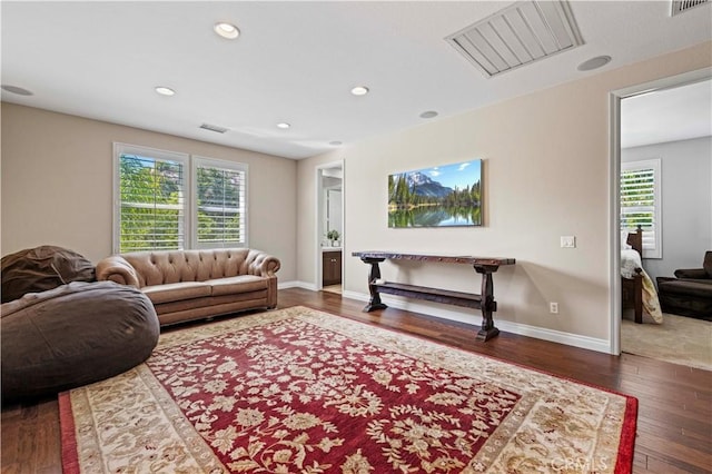 living room featuring plenty of natural light and dark wood-type flooring