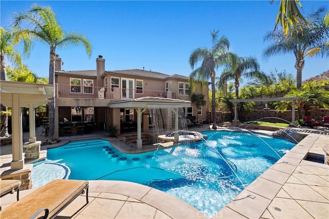 view of pool with a patio area and pool water feature