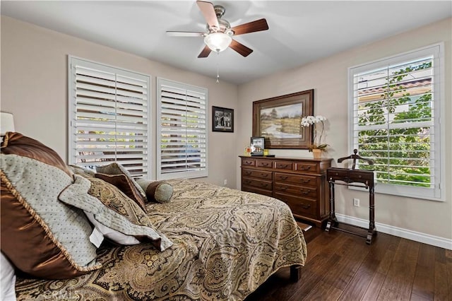 bedroom with multiple windows, ceiling fan, and dark hardwood / wood-style flooring