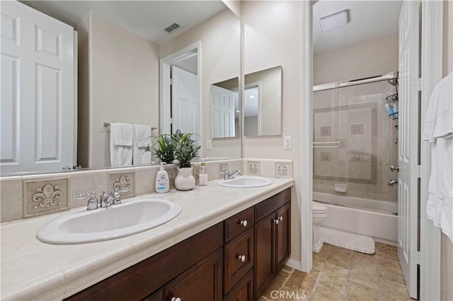 full bathroom with shower / bath combination with glass door, vanity, and toilet