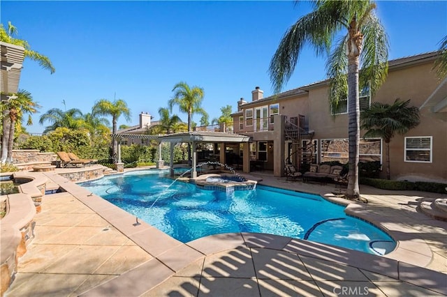 view of swimming pool with an in ground hot tub and a patio area