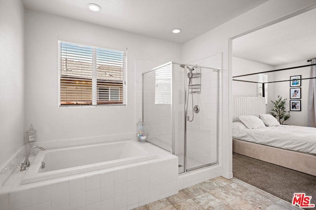 bathroom with separate shower and tub