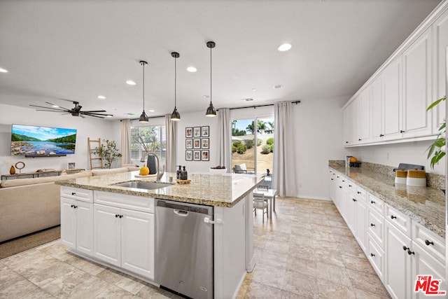 kitchen with ceiling fan, sink, dishwasher, white cabinetry, and an island with sink