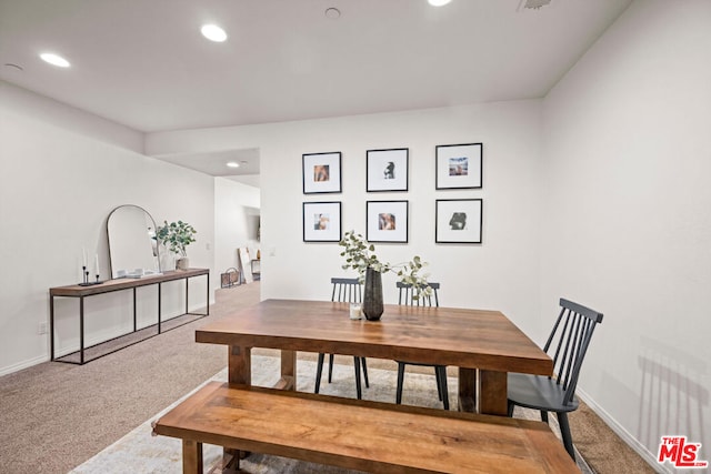 carpeted dining area with radiator heating unit