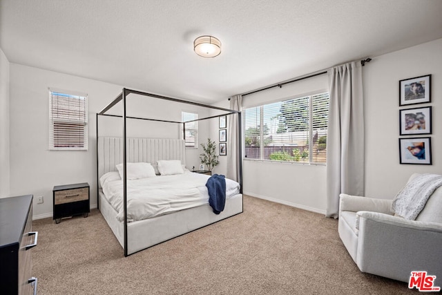 carpeted bedroom featuring a textured ceiling