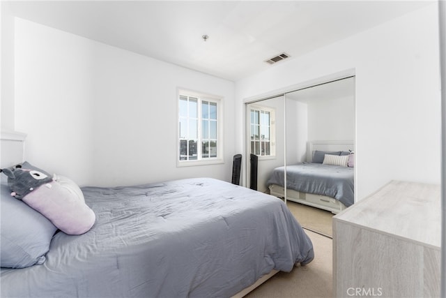 carpeted bedroom featuring a closet