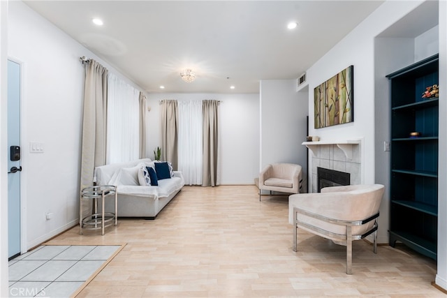 living room featuring light hardwood / wood-style flooring and a fireplace