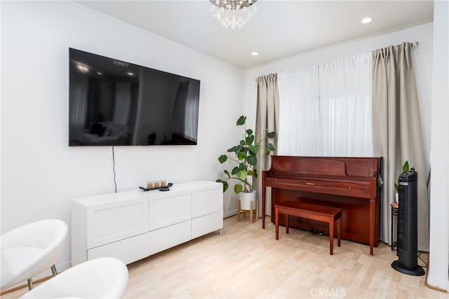 interior space with light hardwood / wood-style floors and a notable chandelier