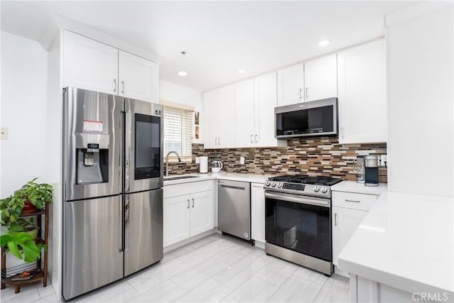 kitchen featuring white cabinetry, sink, and stainless steel appliances