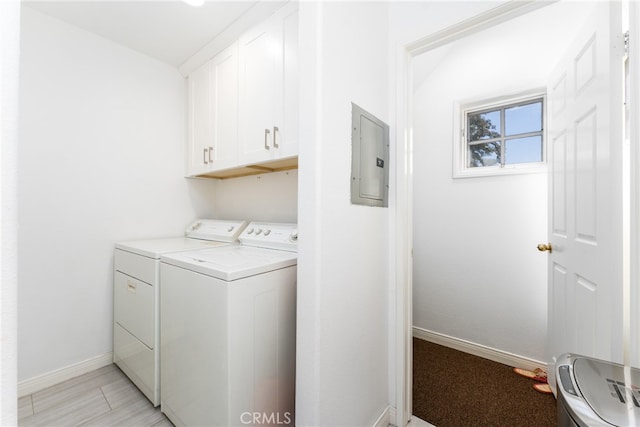 washroom with washer and clothes dryer, electric panel, and cabinets