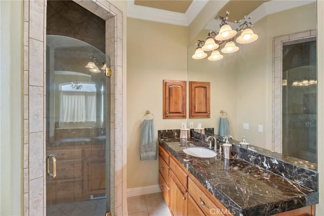 bathroom with vanity, tile patterned flooring, crown molding, and a shower with door