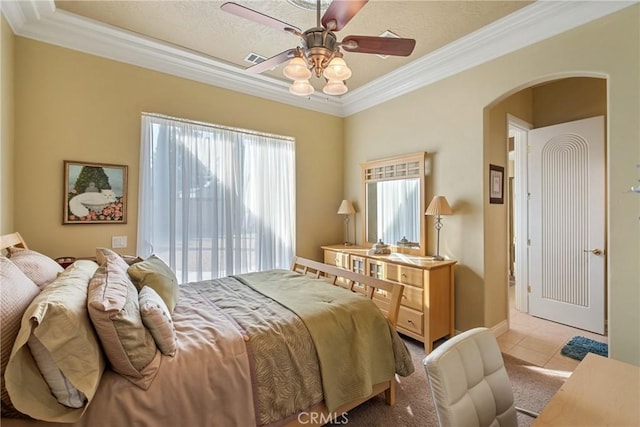 tiled bedroom with crown molding, ceiling fan, and multiple windows