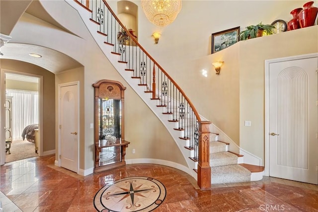 stairway featuring a high ceiling