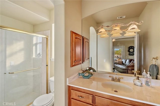 bathroom with vanity, toilet, and an enclosed shower