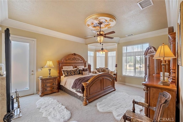 carpeted bedroom with a textured ceiling, ornamental molding, and ceiling fan