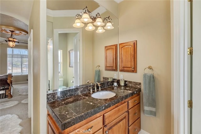 bathroom featuring vanity, toilet, and ceiling fan