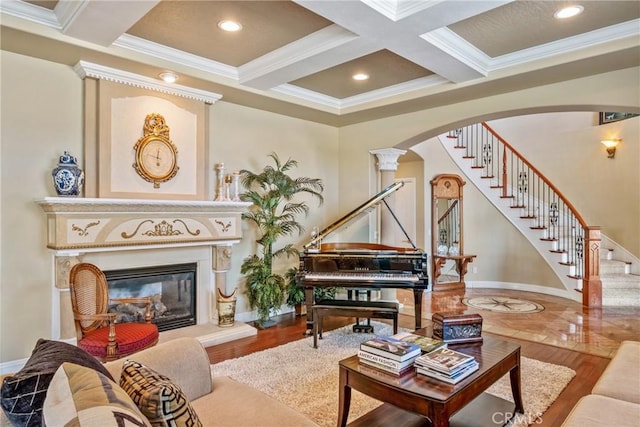 living room with coffered ceiling, hardwood / wood-style flooring, ornamental molding, and beamed ceiling