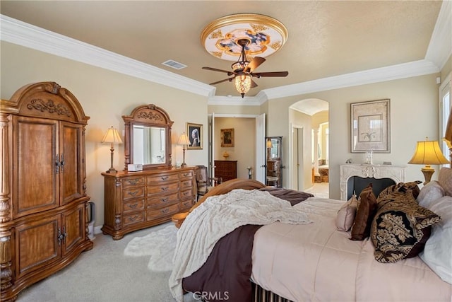 carpeted bedroom with crown molding, ceiling fan, and ensuite bath