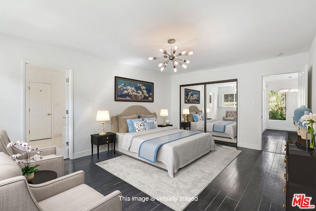 bedroom featuring dark wood-type flooring and a notable chandelier