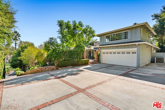 front facade with central AC and a garage