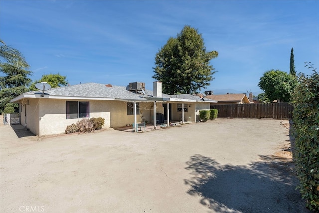 back of property with a patio and cooling unit