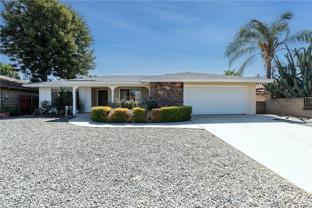 single story home with an attached garage, stucco siding, fence, and concrete driveway