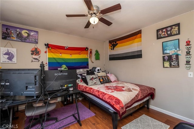 bedroom featuring baseboards, a ceiling fan, and wood finished floors