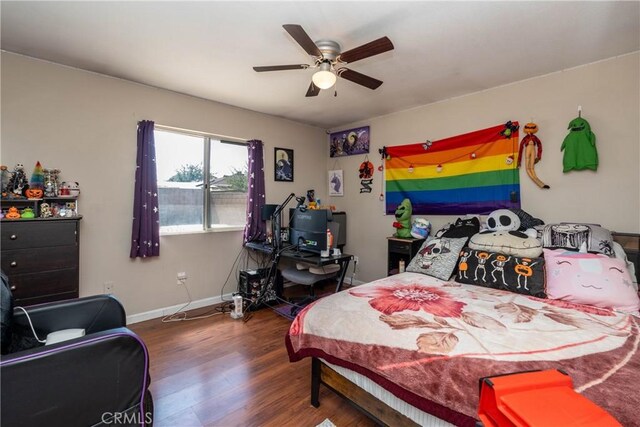 bedroom with wood finished floors, a ceiling fan, and baseboards