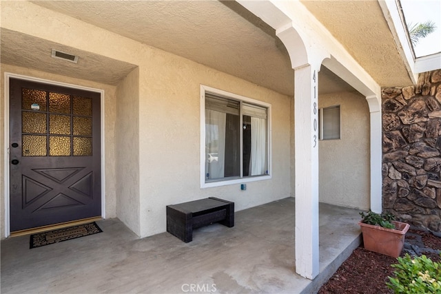 property entrance with a patio area