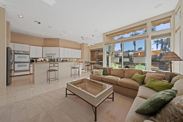 living room with ceiling fan and light tile patterned floors