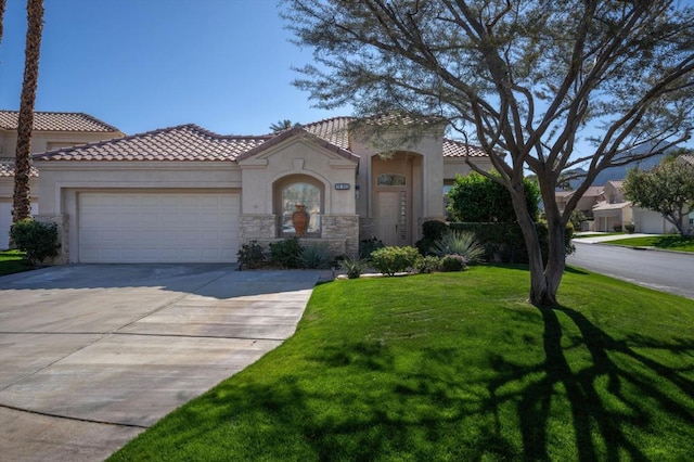 mediterranean / spanish house featuring a front yard and a garage